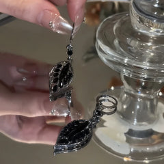 Close-up detail of the sparkling zircons and plating on the gold tassel earrings