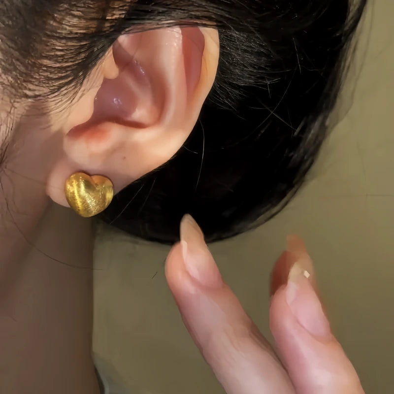 Angled view of the 14K Gold-Pated Brushed Heart Stud Earrings