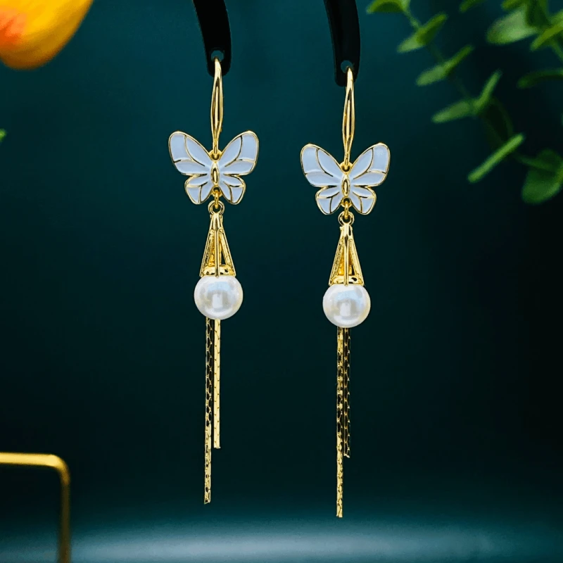 Close-up detail of the sparkling zircons and plating on the gold butterfly earrings