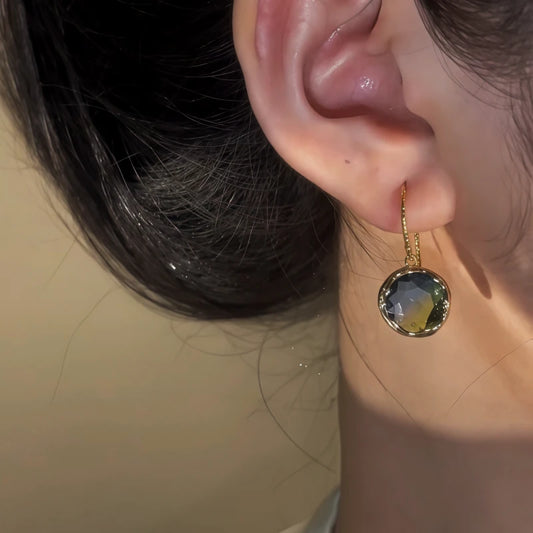 Model showcasing the dangle and style of the 14K Gold-Pated Gradient Glass Crystal Ear Hook Earrings