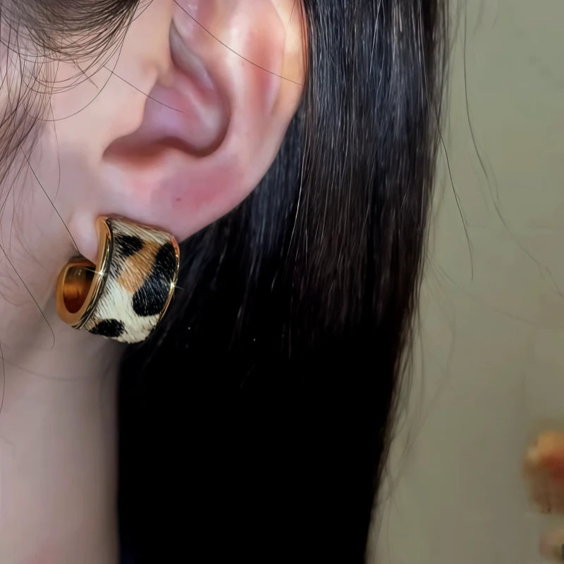 Close-up detail of the sparkling zircons and plating on the leopard print earrings