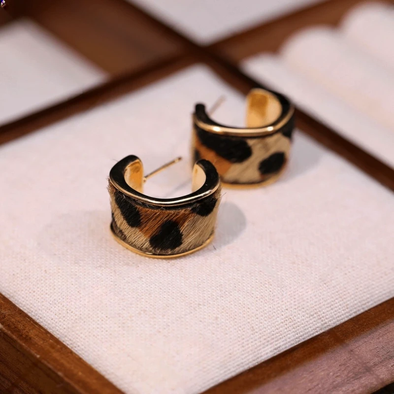 Angled view of the 14K Gold-Pated Leopard Print C-Shaped Hoop Earrings