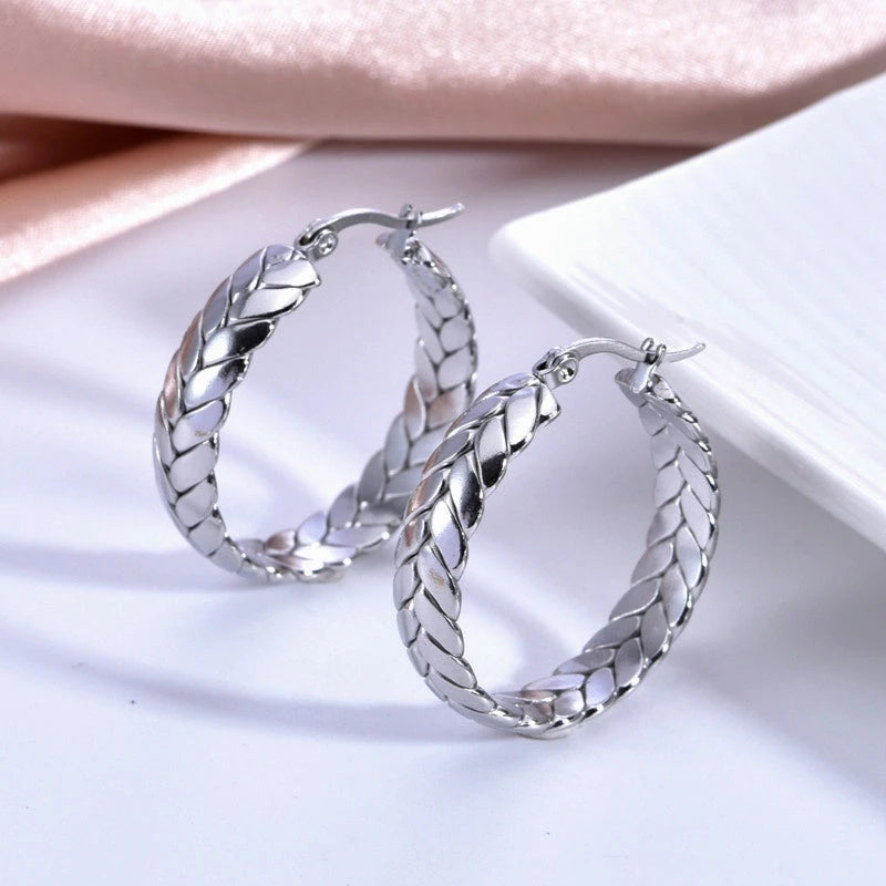 Model showcasing the dangle and style of the 14K Gold-Pated Wheat Hoop Earrings