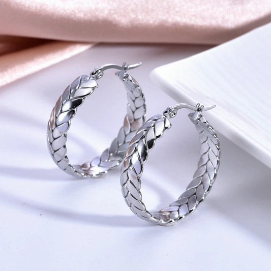 Model showcasing the dangle and style of the 14K Gold-Pated Wheat Hoop Earrings