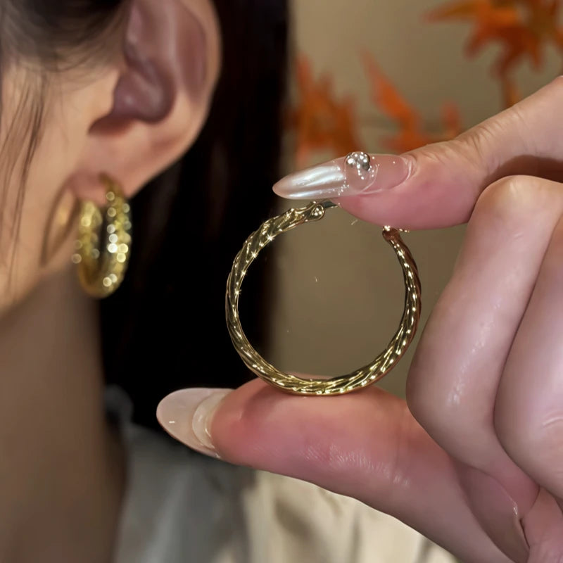 Close-up detail of the sparkling zircons and plating on the gold hoop earrings