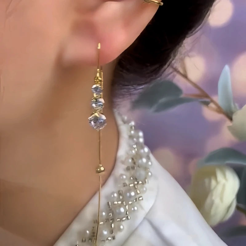 Close-up detail of the sparkling zircons and plating on the gold threader earrings