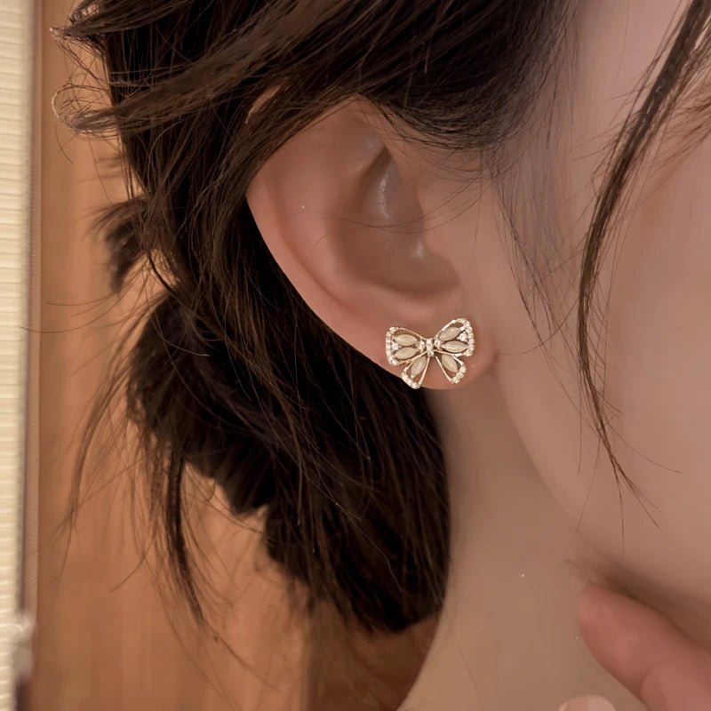 Close-up detail of the sparkling zircons and plating on the gold tassel earrings