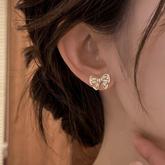 Close-up detail of the sparkling zircons and plating on the gold tassel earrings