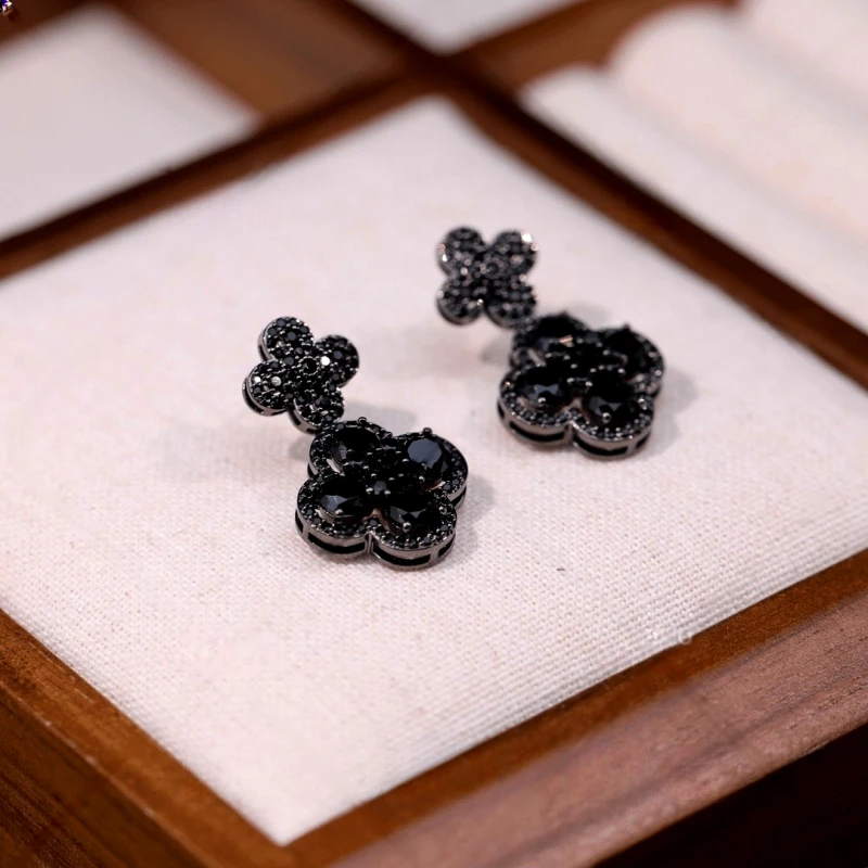 Close-up detail of the sparkling zircons and plating on the clover earrings