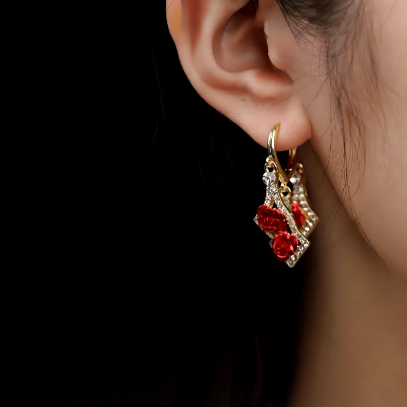 Model showcasing the dangle and style of the 14K Gold-Pated Zircon Rose Tassel Earrings