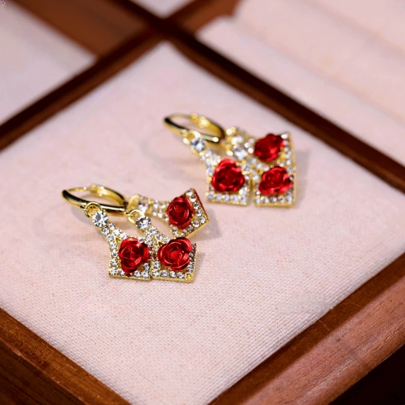 Close-up detail of the sparkling zircons and plating on the gold tassel earrings