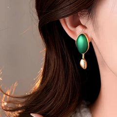 Close-up detail of the sparkling zircons and plating on the gold drop earrings