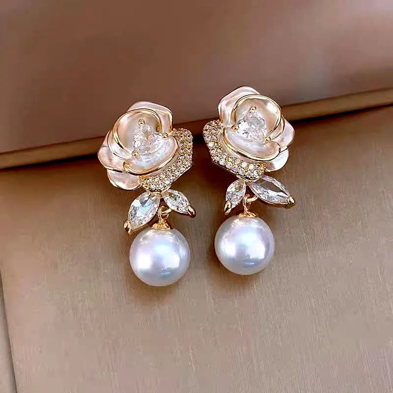 Model showcasing the dangle and style of the 14K Gold-Plated 2025 Elegant French Drip Glaze Camellia Pearl Earrings
