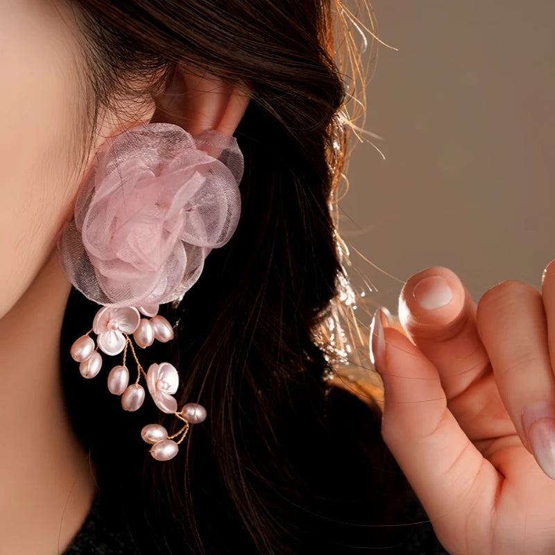 Close-up detail of the sparkling zircons and plating on the gold tassel earrings