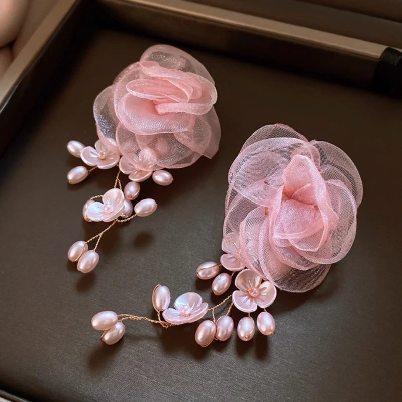 Model showcasing the dangle and style of the 14K Gold-Plated 2025 Elegant Mesh Flower Pearl Tassel Earrings