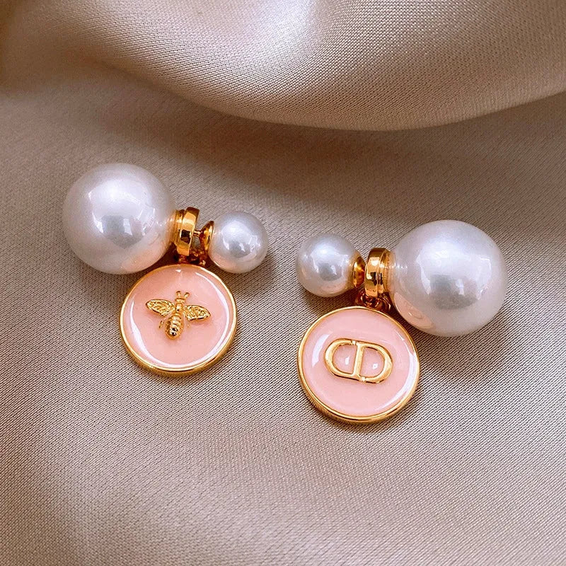 Model showcasing the dangle and style of the 14K Gold-Plated 2025 Elegant Oil Drop Round Pig Nose Bee Pearl Earrings