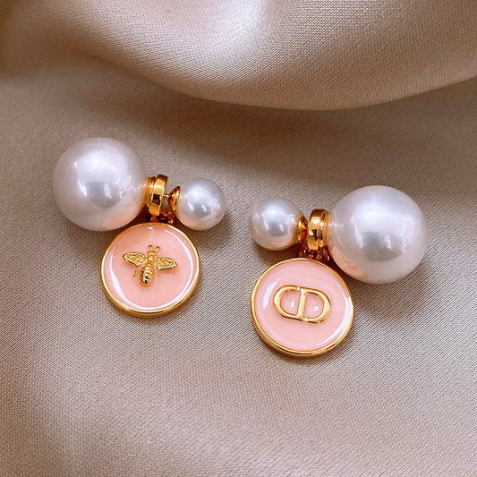 Model showcasing the dangle and style of the 14K Gold-Plated 2025 Elegant Oil Drop Round Pig Nose Bee Pearl Earrings