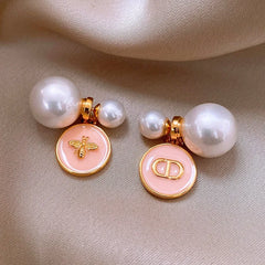 Model showcasing the dangle and style of the 14K Gold-Plated 2025 Elegant Oil Drop Round Pig Nose Bee Pearl Earrings