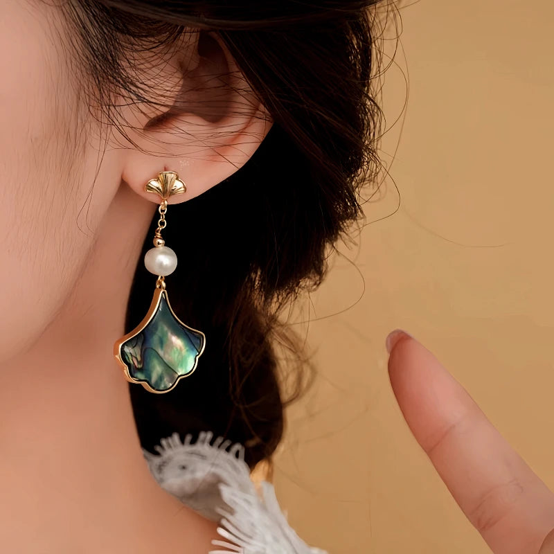 Angled view of the 14K Gold-Plated 2025 Elegant Pearl Leaf Earrings