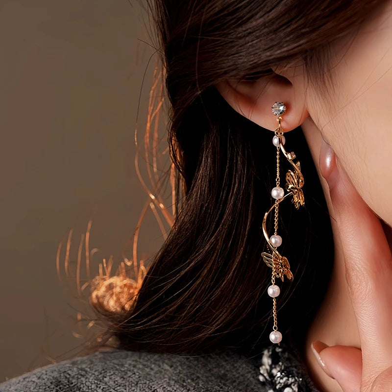 Close-up detail of the sparkling zircons and plating on the gold butterfly earrings