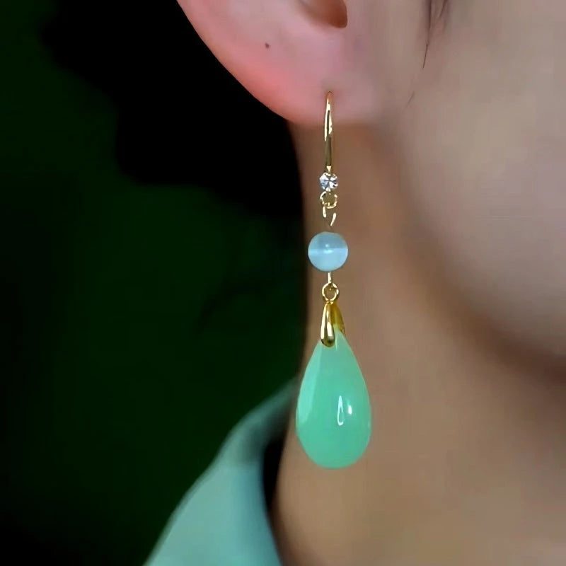 Close-up detail of the sparkling zircons and plating on the gold threader earrings