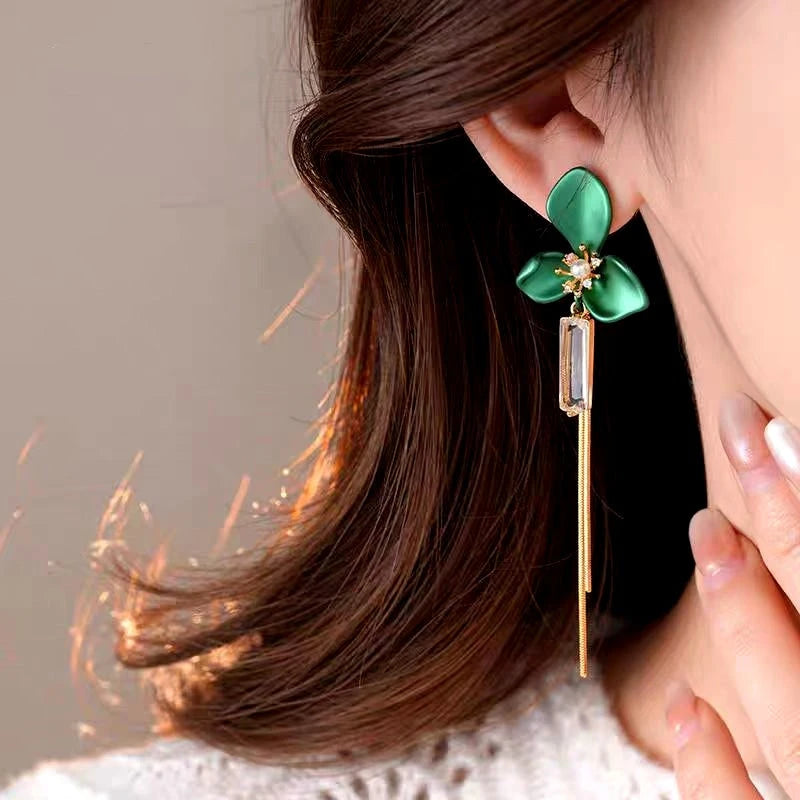 Close-up detail of the sparkling zircons and plating on the gold tassel earrings