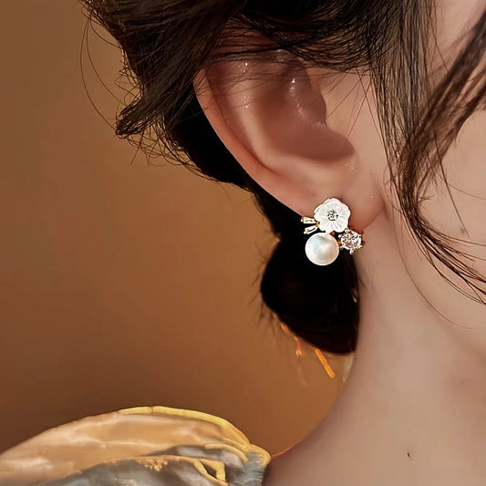 Model showcasing the dangle and style of the 14K Gold-Plated 2025 Elegant Zircon Flower Pearl Earrings