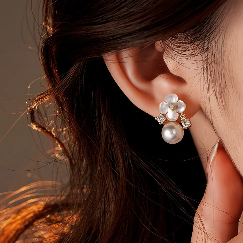 Close-up detail of the sparkling zircons and plating on the gold flower earrings