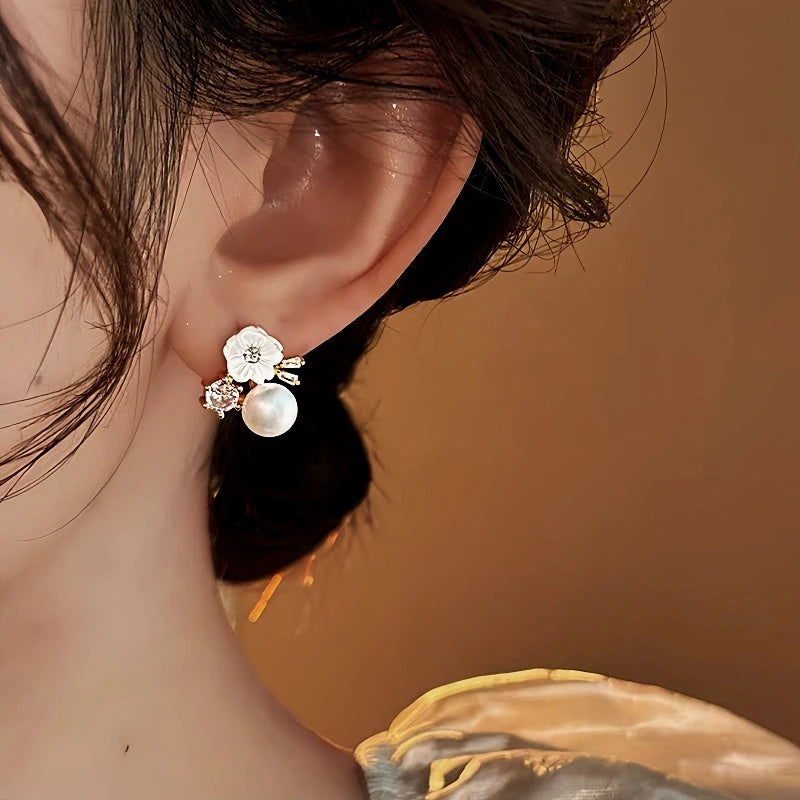 Close-up detail of the sparkling zircons and plating on the gold flower earrings