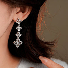 Close-up detail of the sparkling zircons and plating on the silver tassel earrings
