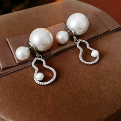 Model showcasing the dangle and style of the 14K Gold-Plated 2025 Elegant Zircon Gourd Pearl Earrings