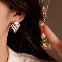 Model showcasing the dangle and style of the 14K Gold-Plated 2025 Elegant Zircon Heart Firework Earrings