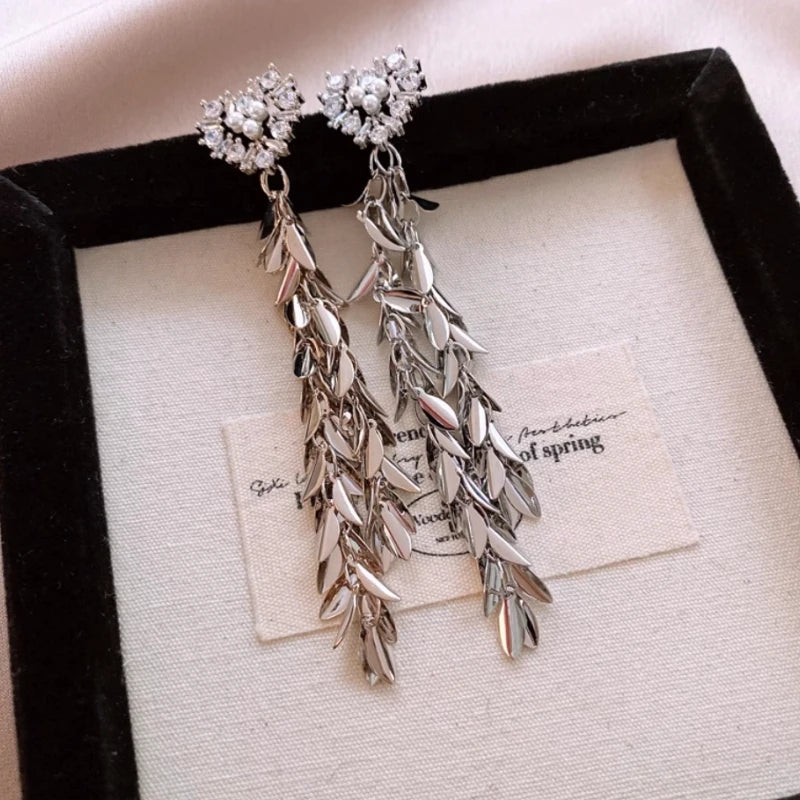 Angled view of the 14K Gold-Plated 2025 Elegant Zircon Pearl Heart Wheat Tassel Earrings