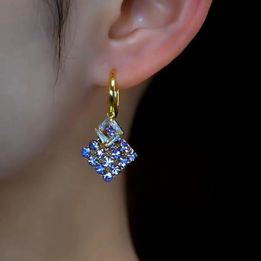 Model showcasing the dangle and style of the 14K Gold-Plated 2025 Elegant Zircon Purple Diamond Earrings