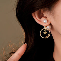 Close-up detail of the sparkling zircons and plating on the silver pearl earrings