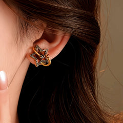 Close-up detail of the sparkling zircons and plating on the silver star earrings