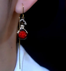 Close-up detail of the sparkling zircons and plating on the gold threader earrings