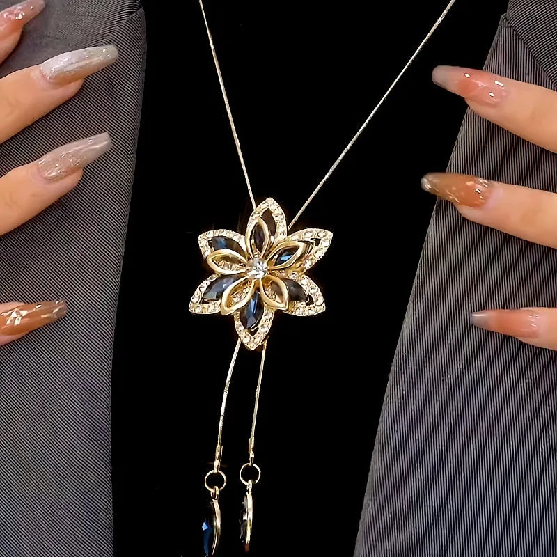 Close-up of the pendant and clasp on the silver tassel necklace