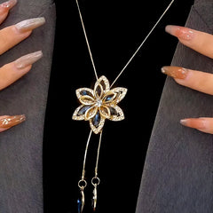 Close-up of the pendant and clasp on the silver tassel necklace