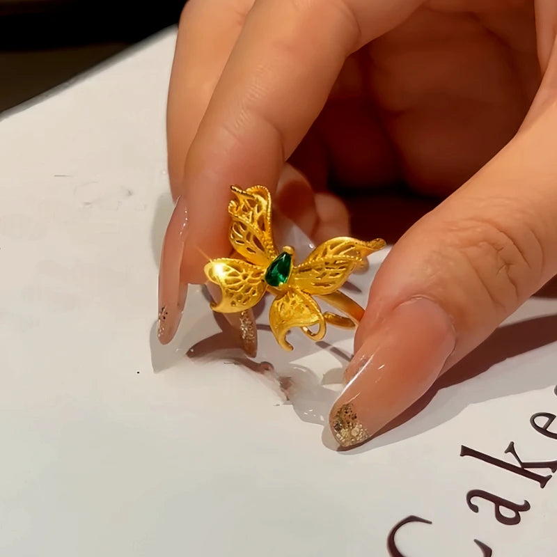 Top-down view of the sparkling 14K Gold-Plated Adjustable Green Diamond Hollow Filigree Butterfly Rings
