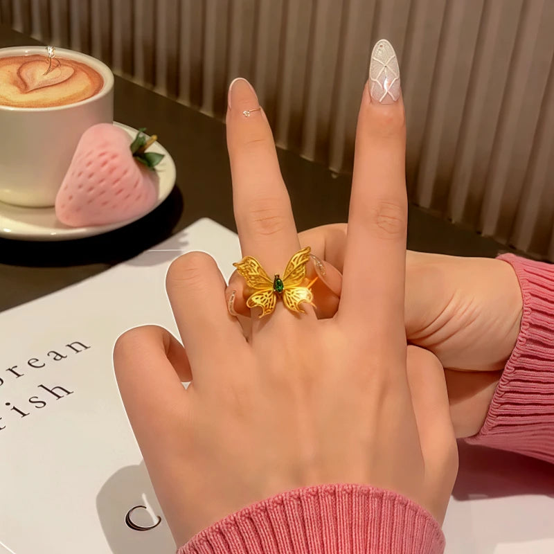 Close-up view of the gemstone and setting of the gold butterfly ring