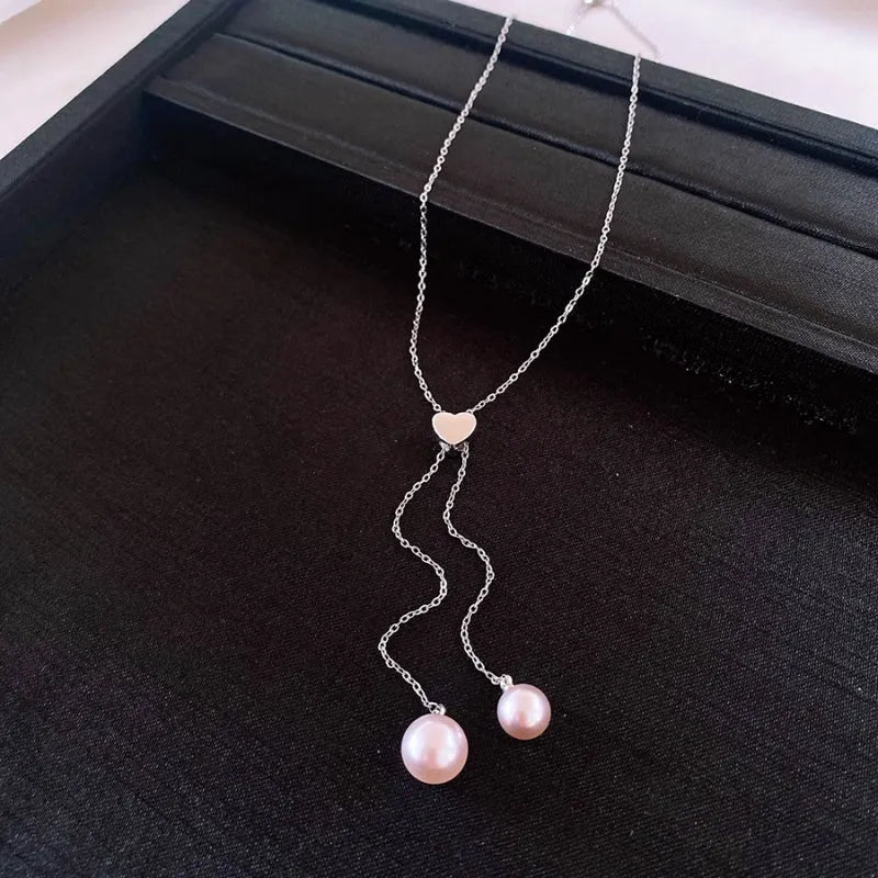 Detailed view of the 14K Gold-Plated Adjustable Heart Pearl Tassel Necklace chain and pendant