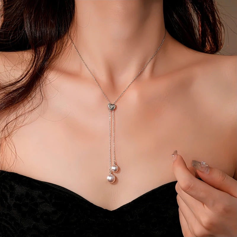 Close-up of the pendant and clasp on the silver tassel necklace