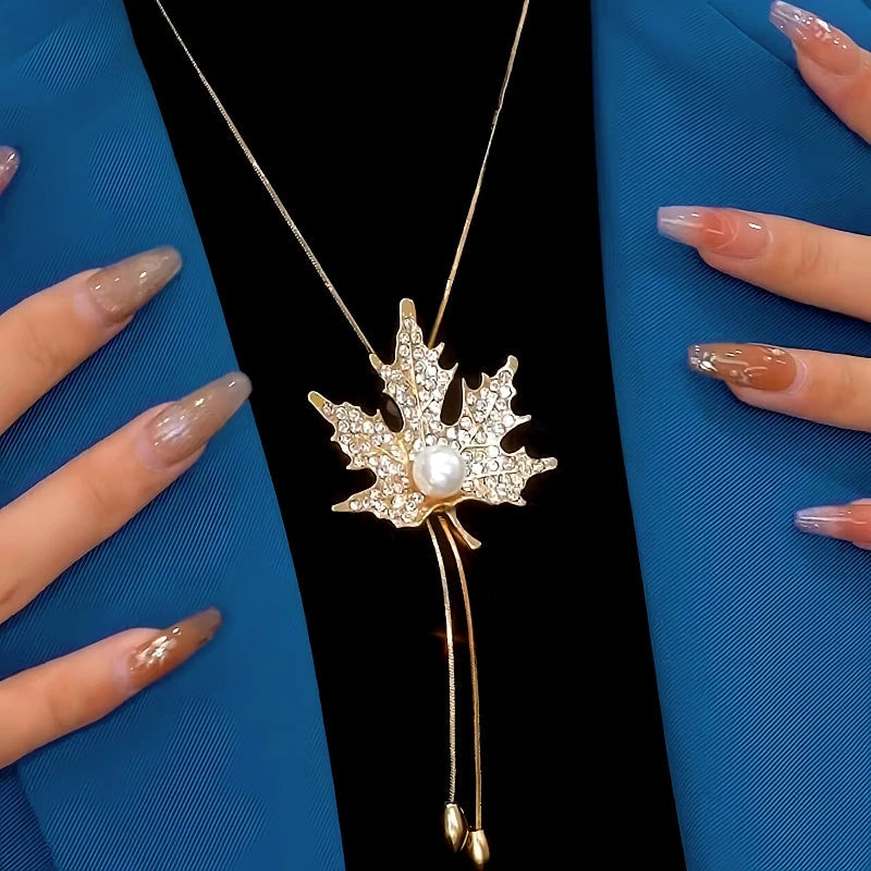 Close-up of the pendant and clasp on the gold leaf necklace