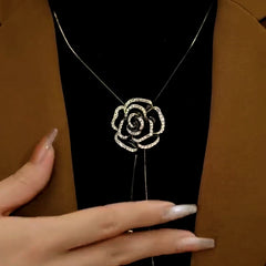 Close-up of the pendant and clasp on the gold rose necklace