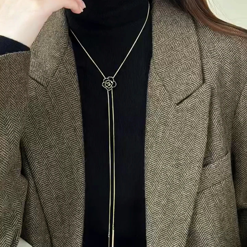 Close-up of the pendant and clasp on the gold rose necklace