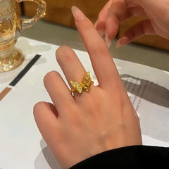 Close-up view of the gemstone and setting of the gold butterfly ring
