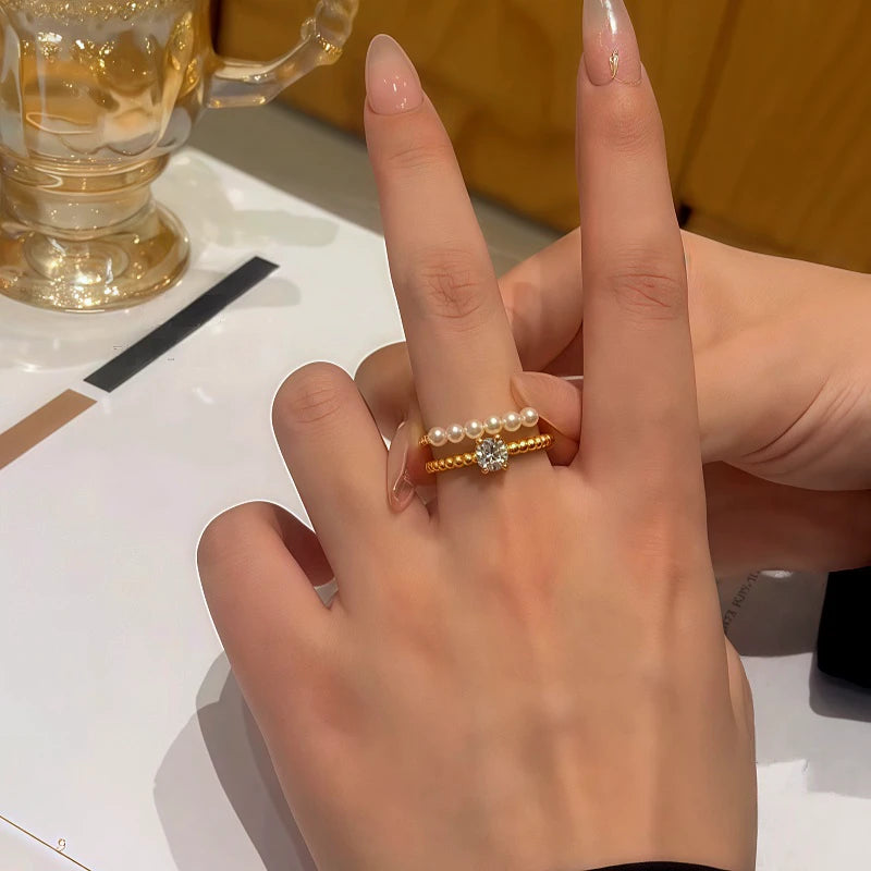 Top-down view of the sparkling 14K Gold-Plated Adjustable Zircon Diamond Pearl Rings