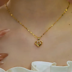 Close-up of the pendant and clasp on the gold heart necklace