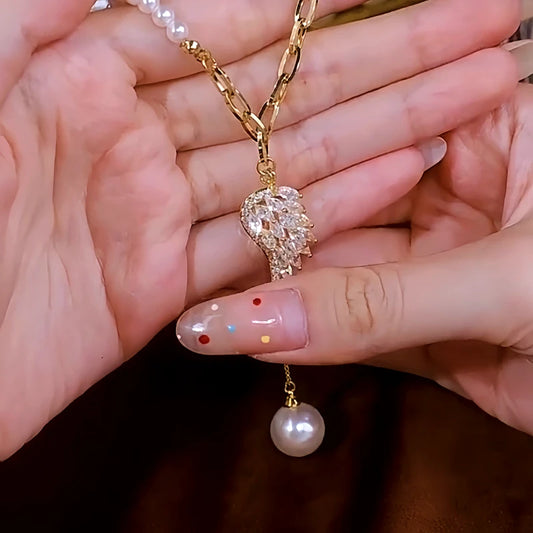 14K Gold-Plated Angel Wing Zircon Pearl Tassel Sweater Necklace worn to showcase its length and pendant detail